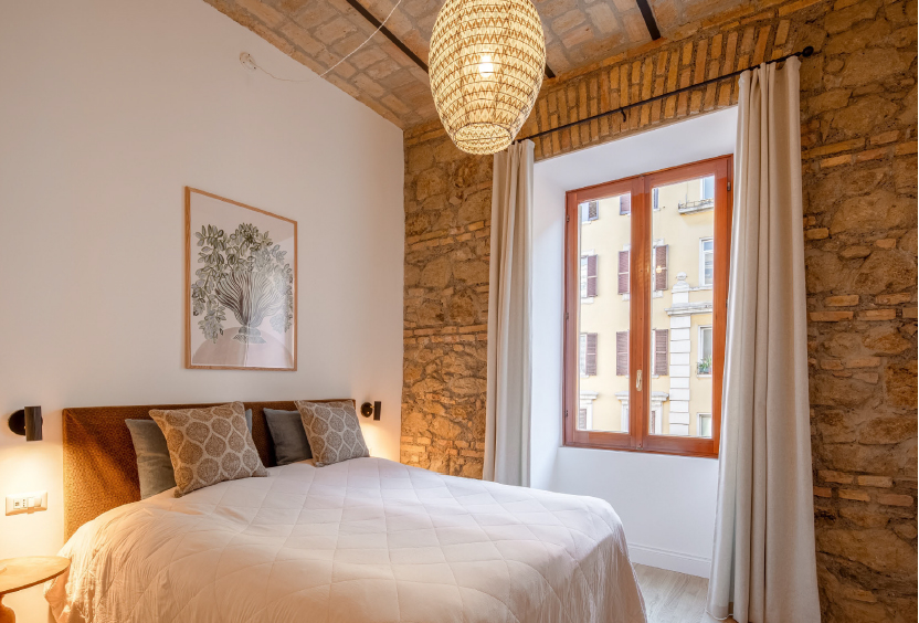 After — bedroom with stone walls